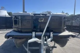 Slide: The Image of 2026 Princecraft Vectra 23 L pontoon boat on trailer, front view under clear sky. - 3