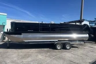 Slide: The Image of 2026 Princecraft Vectra 23 L pontoon boat on trailer, parked outdoors under clear blue sky. - 5