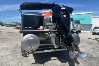 Slide: The Image of 2026 Princecraft Vectra 23 L pontoon boat with outboard motor in a parking lot. - 6
