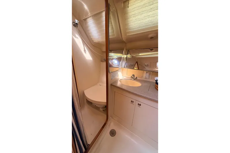 Slide: The Image of Bathroom interior of 2002 Hunter 386 yacht, featuring sink, mirror, and shower area. - 22