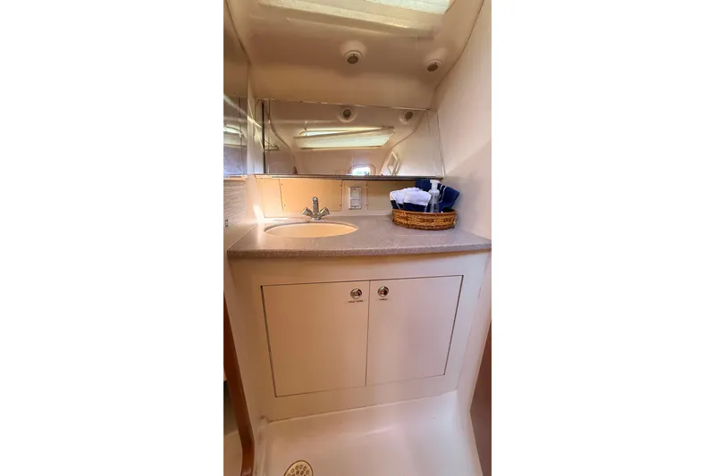 Slide: The Image of Compact bathroom in a 2002 Hunter 386 yacht with sink and mirror. - 24