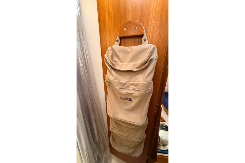 Slide: The Image of Hanging beige storage bag on wooden door inside 2002 Hunter 386 sailboat. - 25