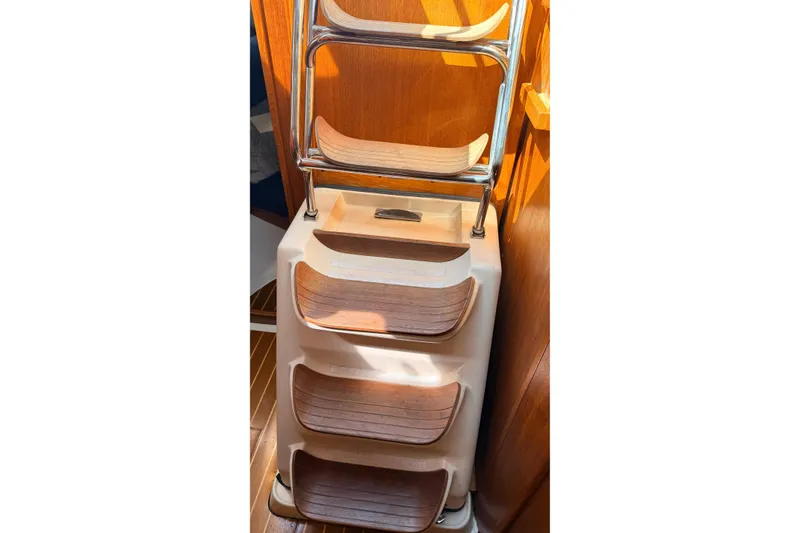 Slide: The Image of Wooden steps with metal railing inside a 2002 Hunter 386 sailboat. - 28