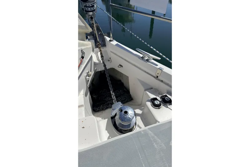 Slide: The Image of Anchor chain and winch on 2002 Hunter 386 sailboat deck. - 32