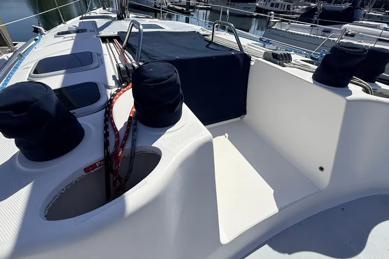 Slide: The Image of 2002 Hunter 386 sailboat deck with winches and ropes in marina setting. - 38