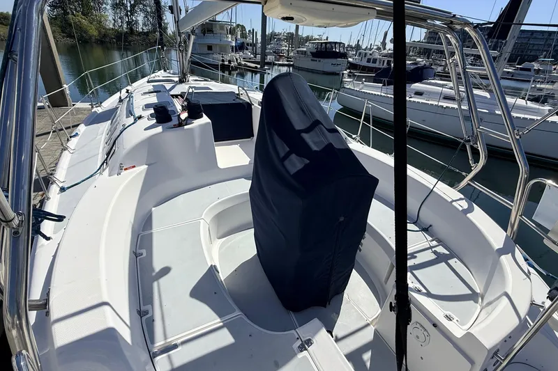 Slide: The Image of 2002 Hunter 386 sailboat cockpit with covered helm, docked at marina. - 42