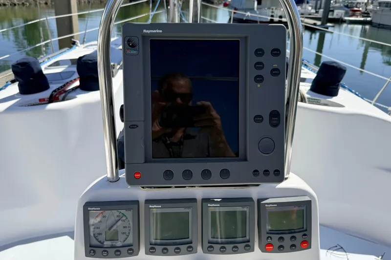 Slide: The Image of Cockpit navigation instruments on a 2002 Hunter 386 sailboat, featuring Raymarine displays. - 44