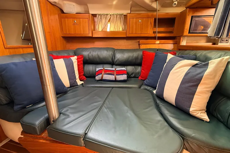 Slide: The Image of Interior of 2002 Hunter 386 yacht with cozy seating and colorful cushions. - 6