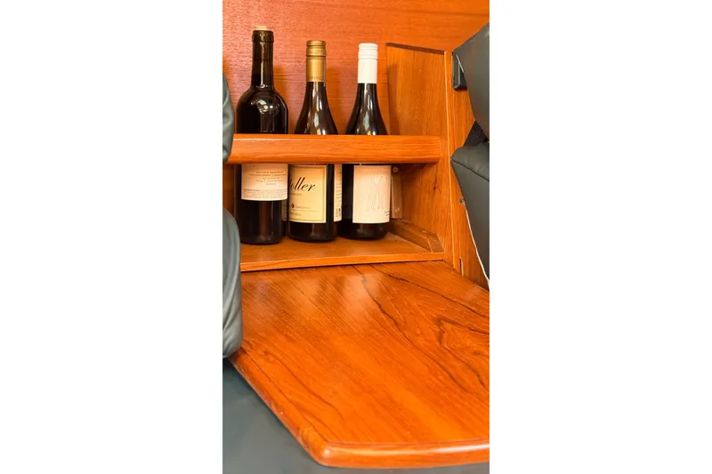 Slide: The Image of Wine bottles stored in a wooden rack on a 2002 Hunter 386 sailboat. - 9