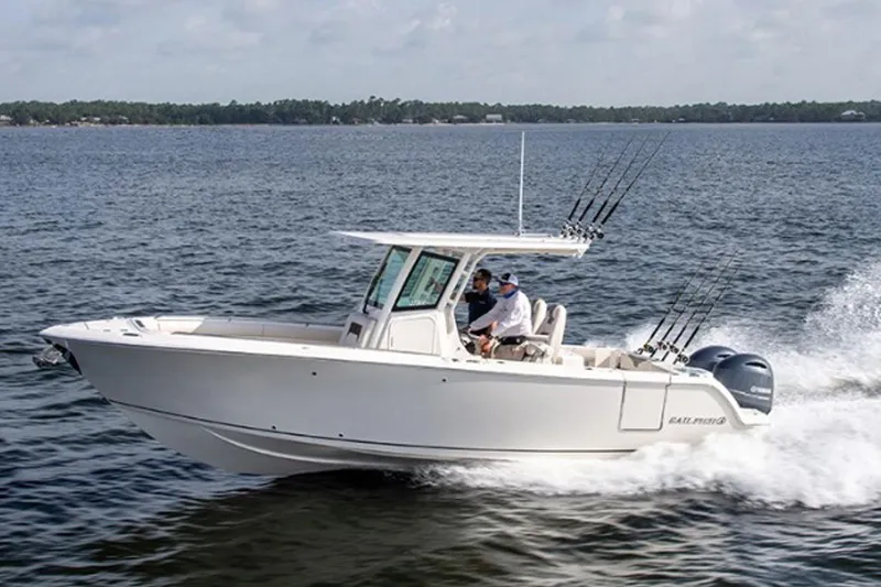 The Image of 2026 Sailfish 272 CC boat cruising on open water with two passengers. - 1