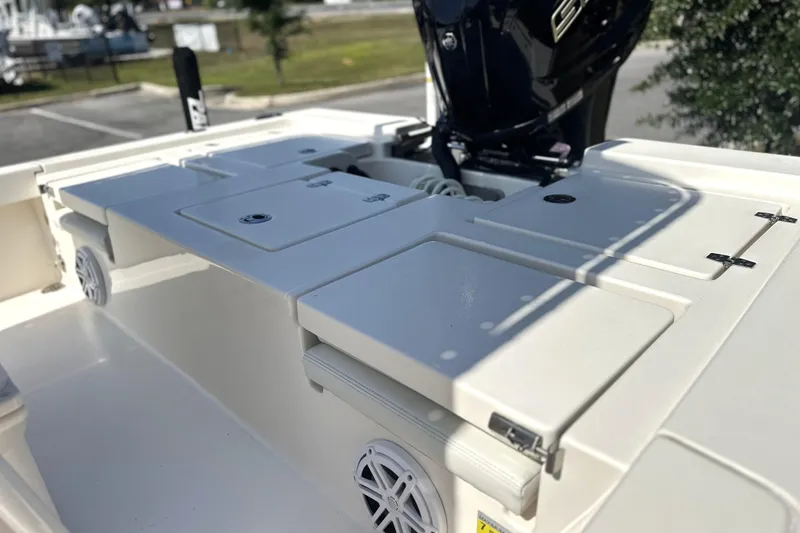 Slide: The Image of 2023 Pathfinder 2200 TRS boat deck with storage compartments and motor. - 13
