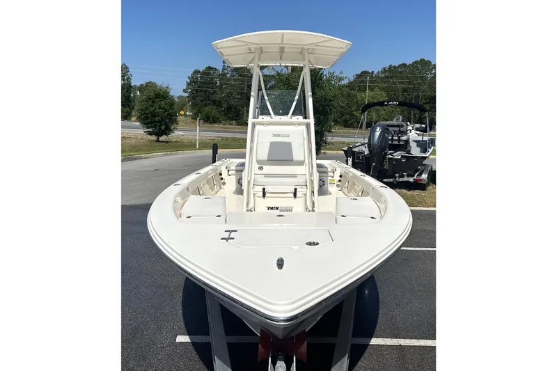 Slide: The Image of 2023 Pathfinder 2200 TRS boat with T-top, parked outdoors on a sunny day. - 15