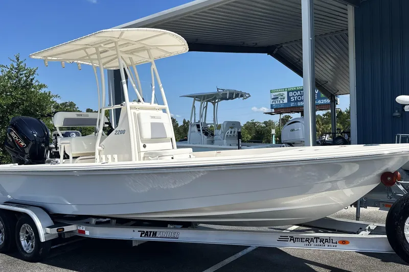 Slide: The Image of 2023 Pathfinder 2200 TRS boat on trailer at dealership. - 16