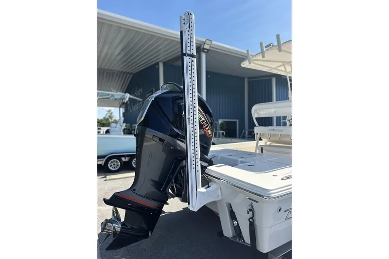 Slide: The Image of 2023 Pathfinder 2200 TRS boat with outboard motor and power pole in marina setting. - 20