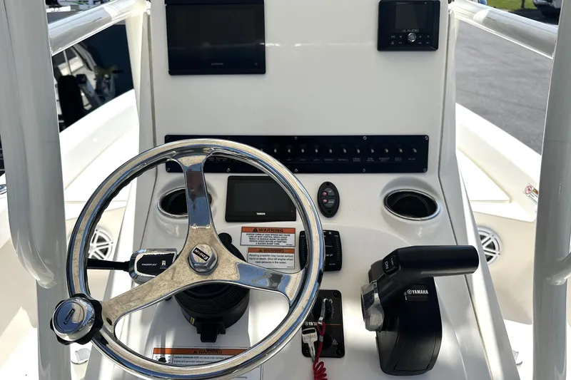 Slide: The Image of 2023 Pathfinder 2200 TRS boat console with steering wheel and Yamaha controls. - 3