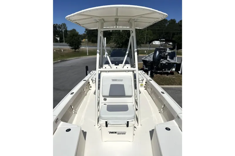 Slide: The Image of 2023 Pathfinder 2200 TRS boat with T-top and seating, parked outdoors. - 4