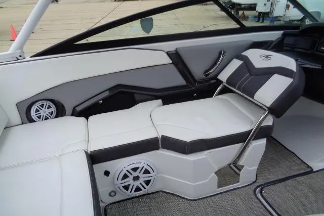 Slide: The Image of 2019 Monterey 218SS Super Sport boat interior with white and black seating, featuring built-in speakers. - 13