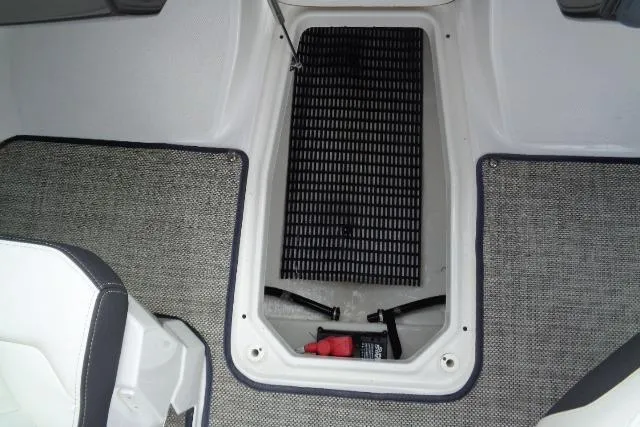 Slide: The Image of 2019 Monterey 218SS Super Sport boat interior storage compartment with carpeted flooring. - 15