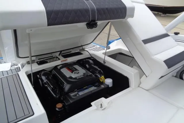 Slide: The Image of 2019 Monterey 218SS Super Sport boat engine compartment with open hatch, showcasing engine details. - 27