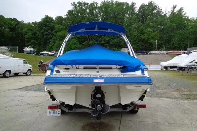 Slide: The Image of 2019 Monterey 218SS Super Sport boat with blue cover, parked outdoors. - 4