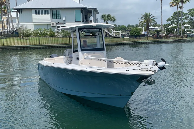 The Image of 2020 Sea Hunt Ultra 275 SE boat on calm water near a residential area. - 0