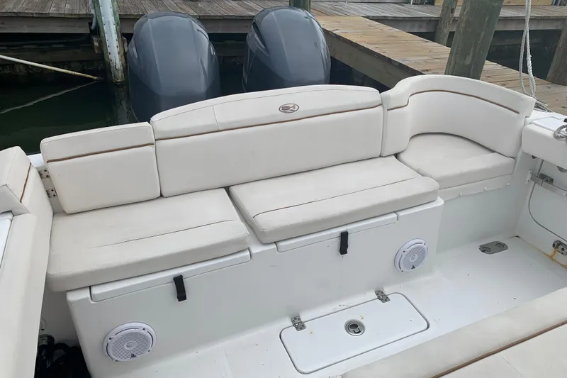 Slide: The Image of 2020 Sea Hunt Ultra 275 SE boat with cushioned seating and dual outboard motors. - 11