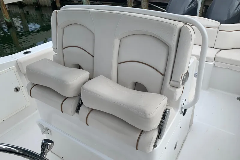 Slide: The Image of 2020 Sea Hunt Ultra 275 SE boat seats with white upholstery and armrests. - 13