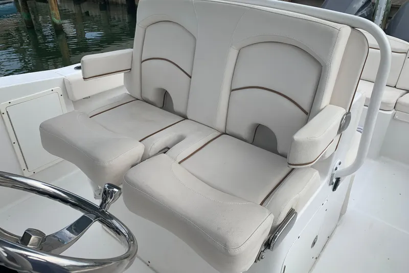 Slide: The Image of Luxury seating on 2020 Sea Hunt Ultra 275 SE boat, featuring plush white upholstery. - 14