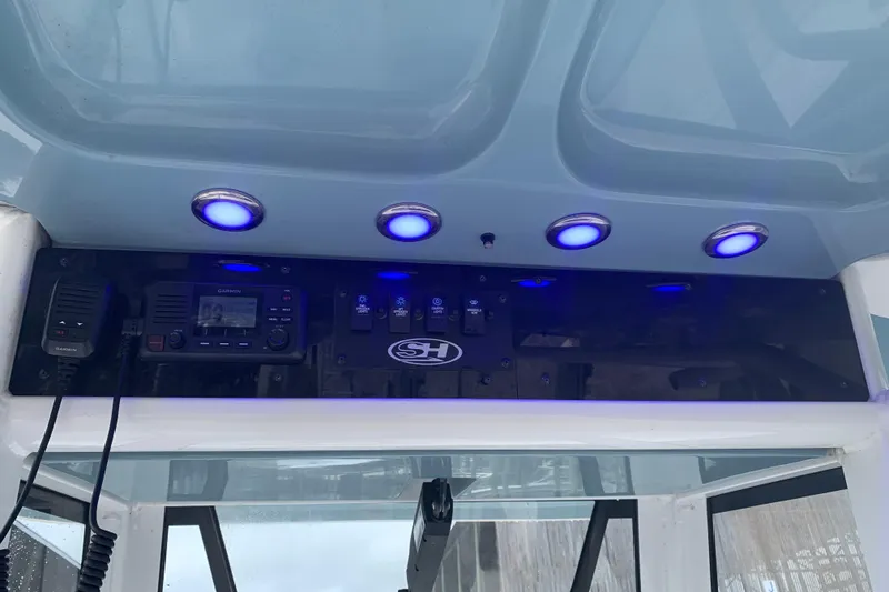 Slide: The Image of 2020 Sea Hunt Ultra 275 SE dashboard with blue LED lights and Garmin radio system. - 7
