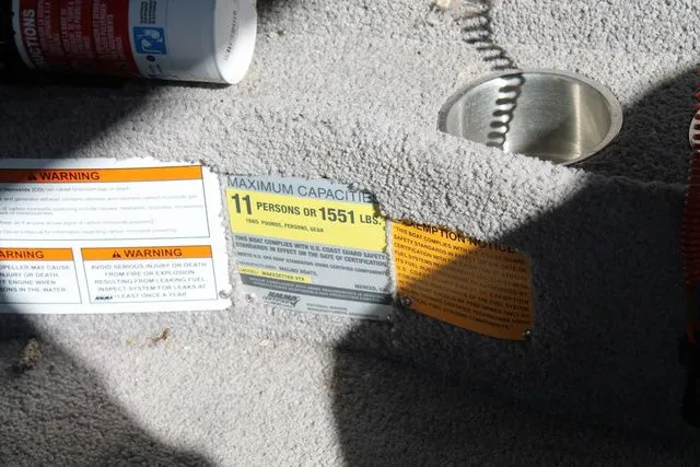 Slide: The Image of 2011 Malibu Wakesetter 20 VTX capacity and warning labels. - 12