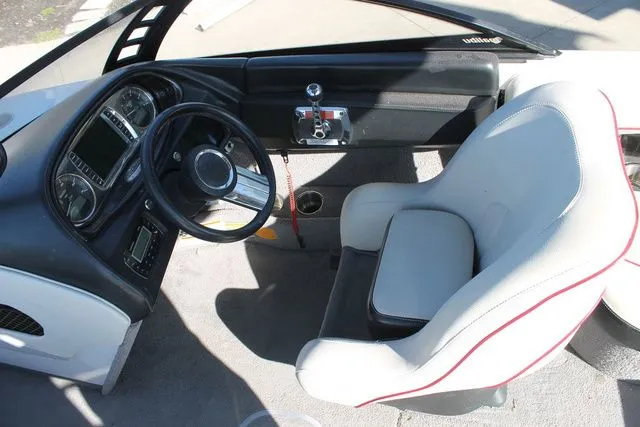 Slide: The Image of Interior of a 2011 Malibu Wakesetter 20 VTX boat, steering wheel and seat. - 8