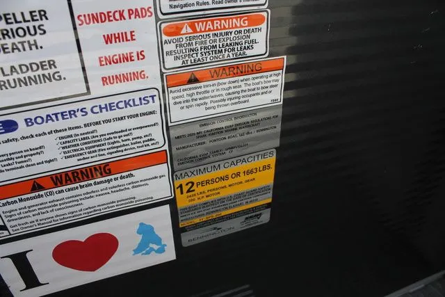 Slide: The Image of Warning labels and capacity sticker on a 2021 Bennington 22 SSRCX boat. - 10