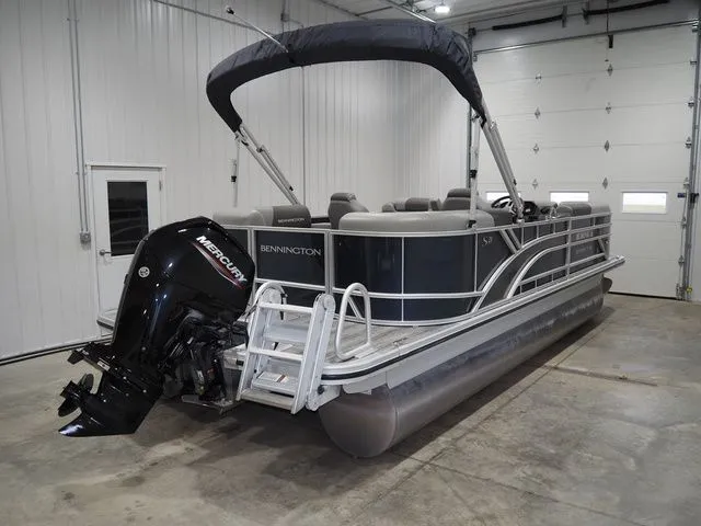 Slide: The Image of 2025 Bennington S Quad Bench 21 SSR pontoon boat in garage. - 5