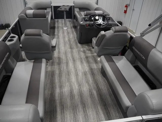 Slide: The Image of 2025 Bennington S Quad Bench 21 SSR interior with gray seating. - 9