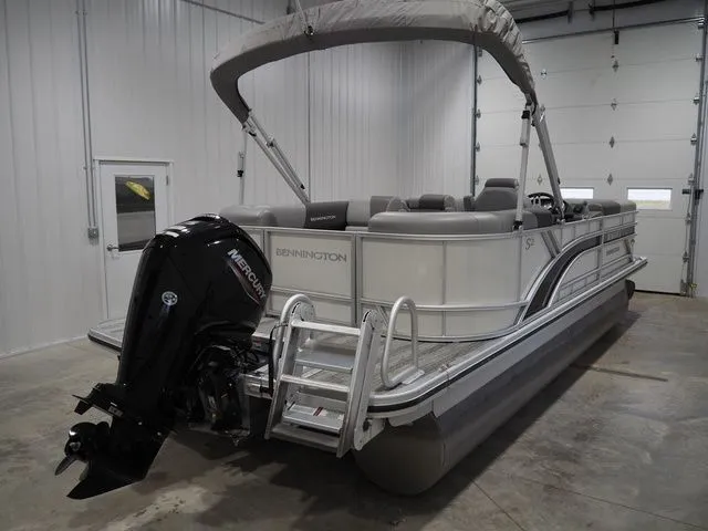 Slide: The Image of 2025 Bennington S Quad Bench 21 SSR pontoon boat in warehouse. - 4