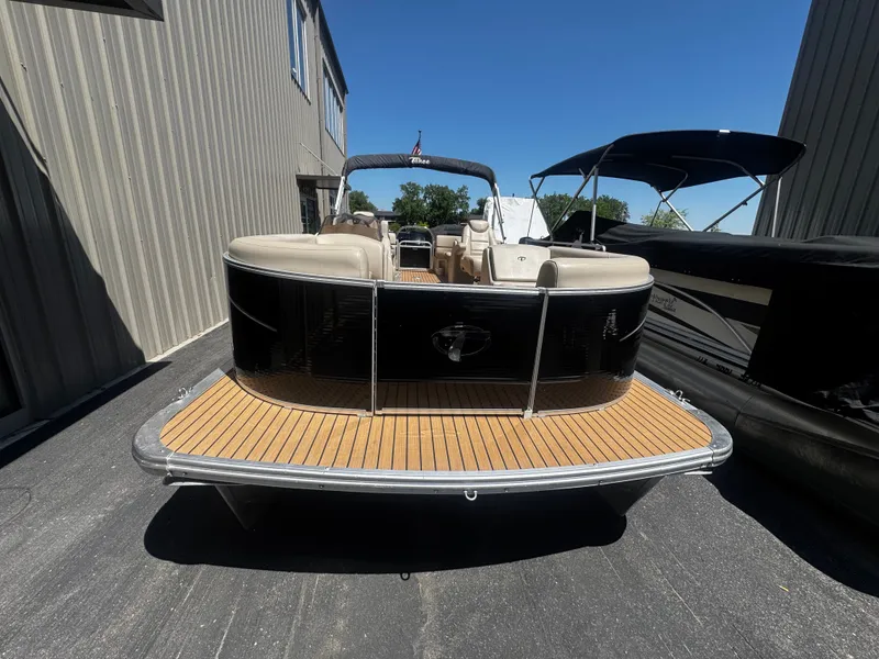 Slide: The Image of 2017 Tahoe LTZ2685 pontoon boat parked outdoors on a sunny day. - 10
