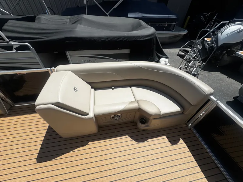 Slide: The Image of 2017 Tahoe LTZ2685 boat with beige seating area and wooden deck. - 6