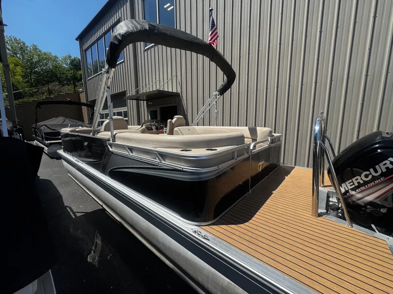 Slide: The Image of 2017 Tahoe LTZ2685 pontoon boat with Mercury engine, parked outside a building. - 8