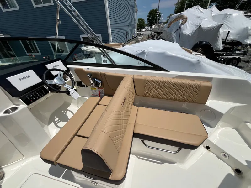 Slide: The Image of Interior of 2026 Sea Ray SDX 250 Outboard boat with beige seating. - 11