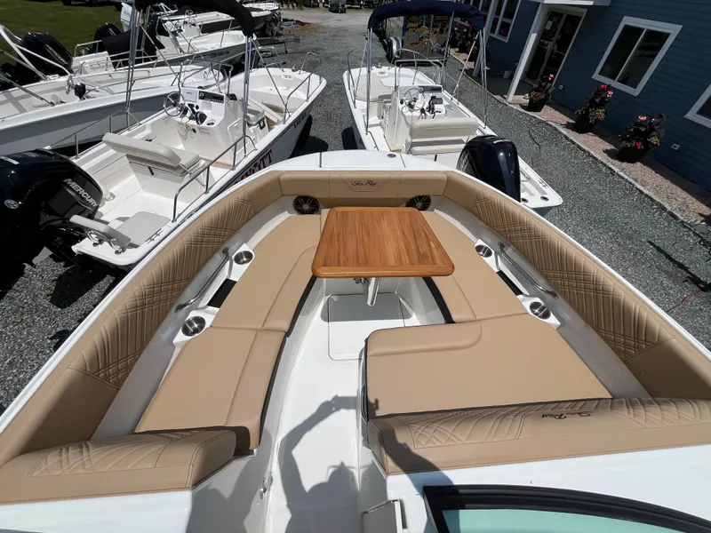 Slide: The Image of 2026 Sea Ray SDX 250 Outboard with luxurious interior and wooden table. - 18