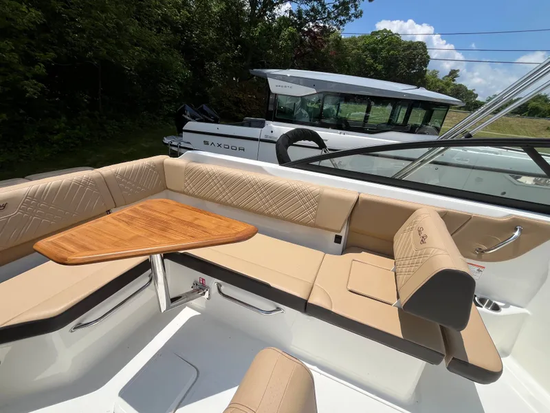 Slide: The Image of Interior of 2026 Sea Ray SDX 250 Outboard with wooden table. - 7