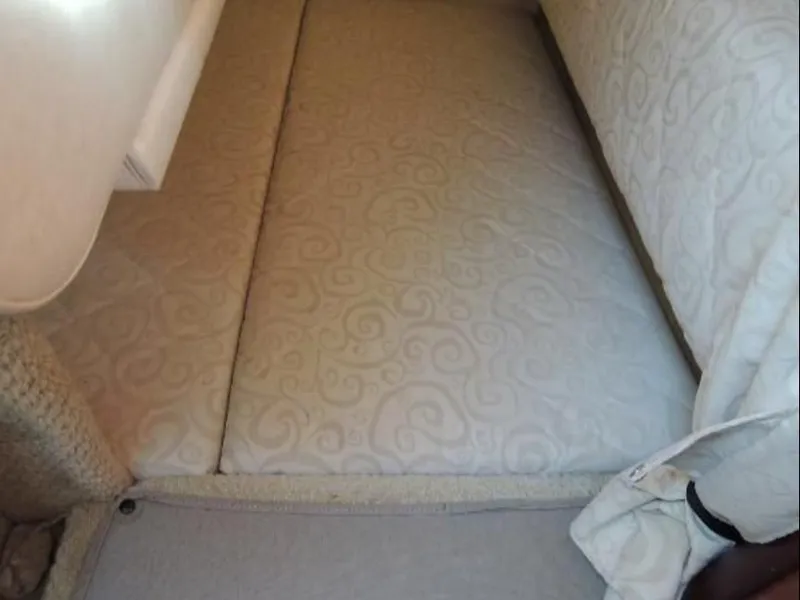 Slide: The Image of Interior of 2005 Sea Ray Sundancer 260 with cushioned bed. - 16