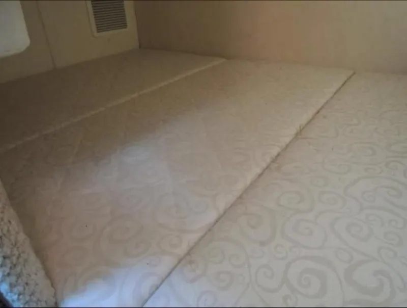 Slide: The Image of Interior of 2005 Sea Ray Sundancer 260 with cushioned bed. - 17