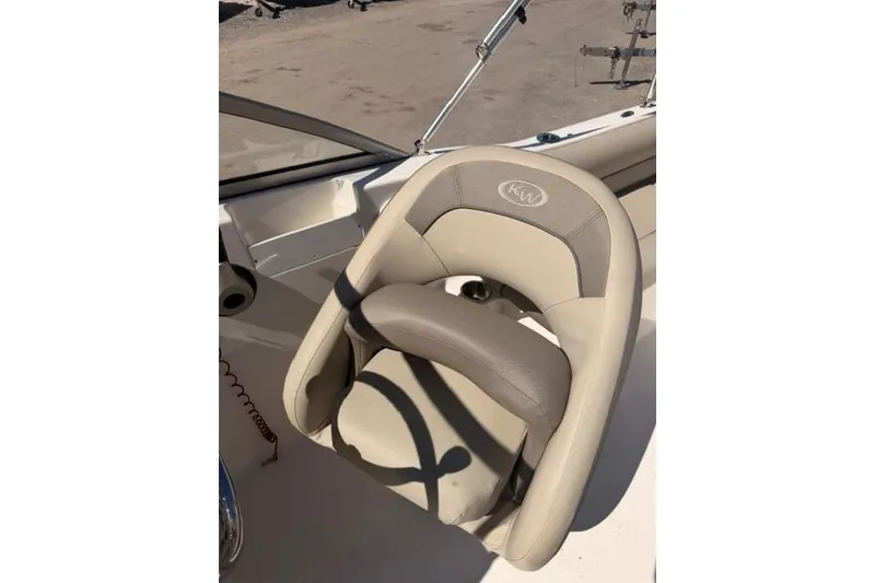 Slide: The Image of Key West 203 DFS 2021 boat seat with beige upholstery and KW logo. - 10