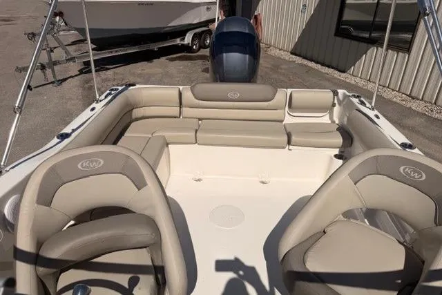 Slide: The Image of 2021 Key West 203 DFS boat interior with beige seating and steering wheel. - 11