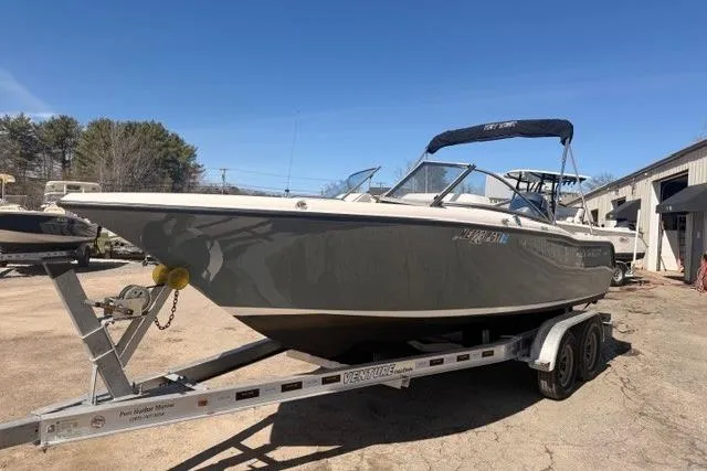Slide: The Image of 2021 Key West 203 DFS boat on trailer, parked outdoors under clear blue sky. - 4
