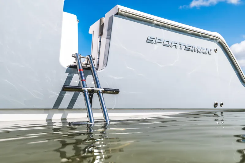 Slide: The Image of 2026 Sportsman Open 262 Center Console boat with ladder, partially submerged in water. - 16