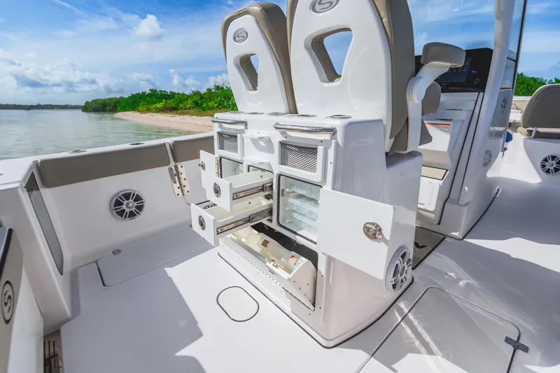 Slide: The Image of 2026 Sportsman Open 262 Center Console boat interior with storage compartments open. - 2