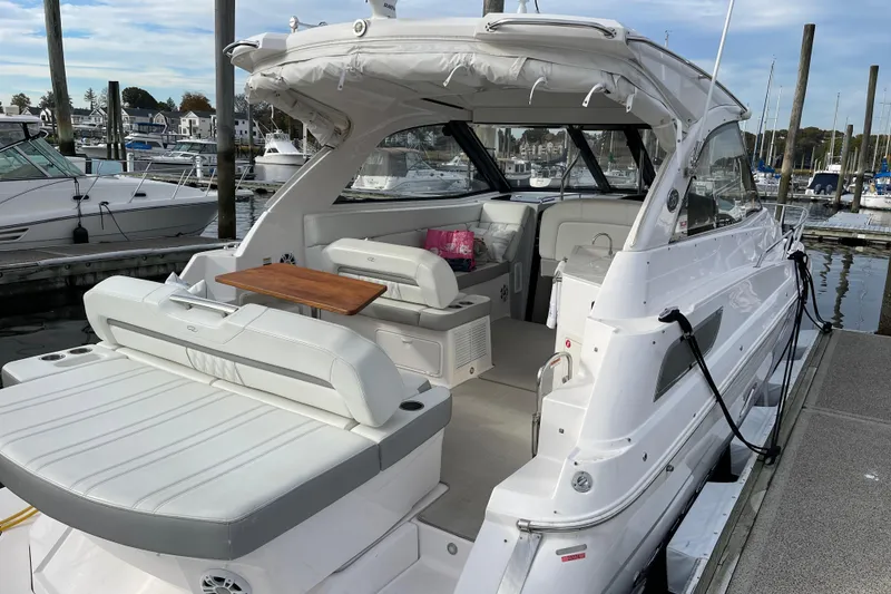 Slide: The Image of 2012 Regal 35 Sport Coupe yacht docked, featuring spacious seating and sleek design. - 10