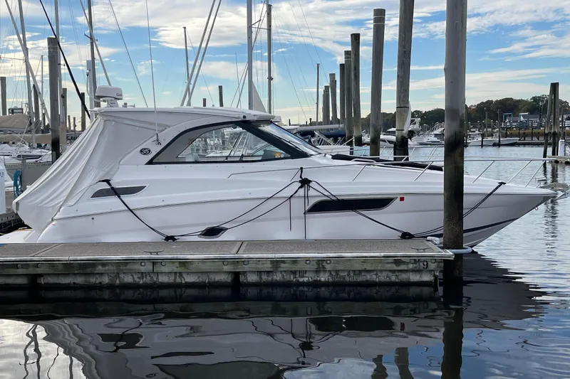 Slide: The Image of 2012 Regal 35 Sport Coupe docked at marina under clear sky. - 13